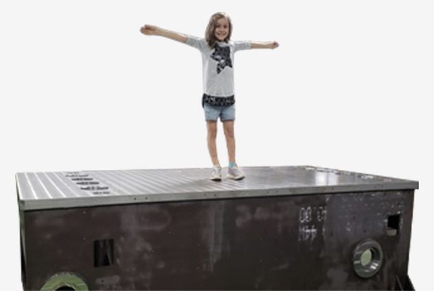 Girl standing on large machine